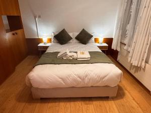 a bedroom with a large bed with two night stands at HausHarder Rooms in Gommiswald