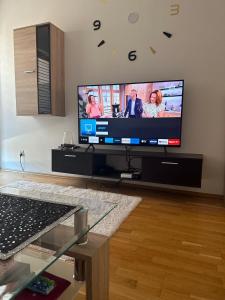 a living room with a large flat screen tv at Apartament Osielsko in Osielsko