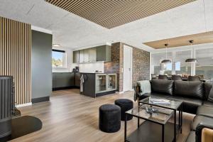 a living room with a couch and a table at 2248-Ringkobing-Vestklitvej-16-A in Klegod