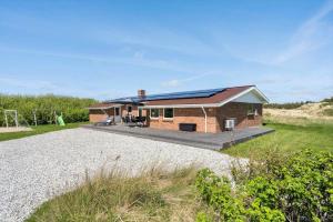 a small house with solar panels on the roof at 2248-Ringkobing-Vestklitvej-16-A in Klegod