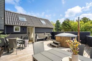 a backyard with a wooden deck with a gazebo at 1196-Ringkobing-Sivsangervej-24 in Nørby