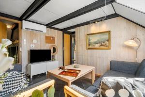 a living room with a couch and a table at 1196-Ringkobing-Sivsangervej-24 in Nørby