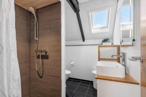 a bathroom with a shower and a sink at 1196-Ringkobing-Sivsangervej-24 in Nørby +32 photos