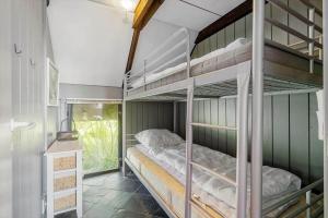 a bedroom with two bunk beds in a room at 1196-Ringkobing-Sivsangervej-24 in Nørby