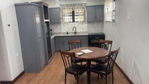 a kitchen with a table and chairs and a sink at Peaceful Paraiso in New Amsterdam