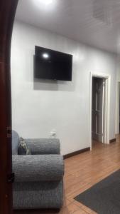 a living room with a couch and a television on a wall at Peaceful Paraiso in New Amsterdam +7 photos