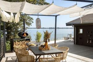 a patio with a table and chairs and a grill at FY325-Munkebo-Kamsbjerghuse-1-b in Munkebo