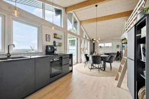 a kitchen with a dining room with a table at FY325-Munkebo-Kamsbjerghuse-1-b in Munkebo