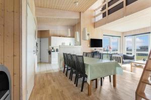 a dining room and kitchen with a table and chairs at FY293-Faaborg-Mosegarden-42 in Faaborg