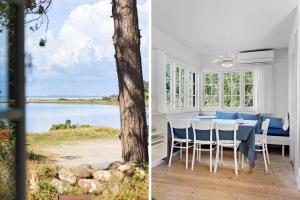 a dining room with a table and a view of the water at FY339-Martofte-Fynshovedvej-786 in Martofte