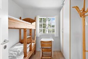 a bedroom with a bunk bed and a desk at FY339-Martofte-Fynshovedvej-786 in Martofte
