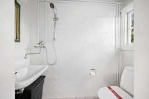 a white bathroom with a shower and a sink at FY339-Martofte-Fynshovedvej-786 in Martofte +27 photos