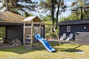 a playground with a slide and a play house at FY339-Martofte-Fynshovedvej-786 in Martofte