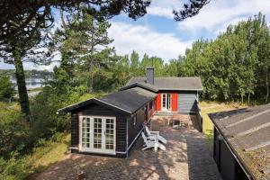 a small house with a patio in front of it at FY339-Martofte-Fynshovedvej-786 in Martofte