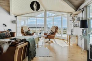 a living room with a couch and chairs and windows at FY289-Faaborg-Avernakovej-22 in Faaborg