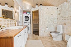 a bathroom with a toilet and a sink at FY289-Faaborg-Avernakovej-22 in Faaborg +13 photos
