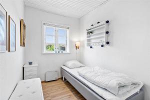 a white room with a bed and a window at FY318-Nyborg-Sommerbyen-23 in Nyborg