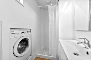 a white laundry room with a washing machine and a sink at FY318-Nyborg-Sommerbyen-23 in Nyborg +14 photos