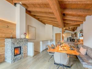a dining room with a table and a fireplace at Wagrainer TauernLodge 42B in Wagrain