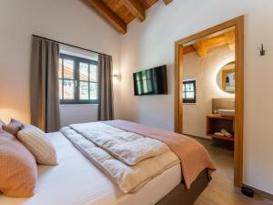 a bedroom with a bed with a window and a mirror at Wagrainer TauernLodge 42B in Wagrain