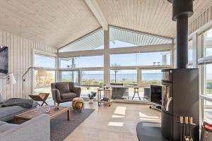 a living room with a couch and a fireplace at FY261-Ebberup-Hasselvaenget-22 in Ebberup
