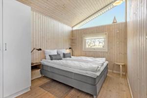 a bedroom with a large bed and a window at FY261-Ebberup-Hasselvaenget-22 in Ebberup