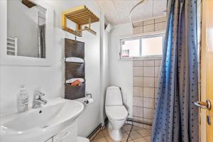 a bathroom with a toilet and a sink at FY349-Svendborg-Blaklokkevej-8 in Svendborg +13 photos