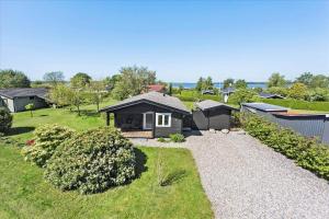 a house with a gravel driveway in a yard at FY349-Svendborg-Blaklokkevej-8 in Svendborg