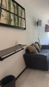 a living room with a couch and a shelf on the wall at Cerro Escondido in Chiapa de Corzo