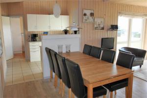 a kitchen and dining room with a wooden table and chairs at FY292-Faaborg-Mosegarden-40 in Faaborg
