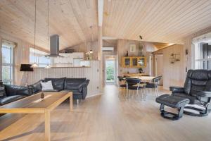 a living room with black leather furniture and a table at FY287-Faaborg-Siovej-12 in Faaborg