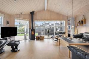a living room with a couch and a fireplace at FY287-Faaborg-Siovej-12 in Faaborg
