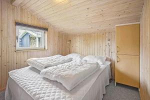 a bedroom with two beds in a wooden wall at FY287-Faaborg-Siovej-12 in Faaborg