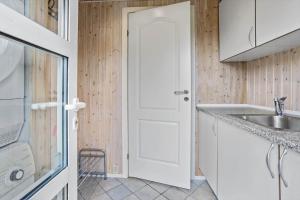 a kitchen with a sink and a white door at FY287-Faaborg-Siovej-12 in Faaborg +15 photos