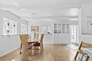 a kitchen and dining room with a table and chairs at FY283-Broby-Sandholtvej-45 in Brolo