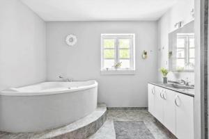 a white bathroom with a tub and a sink at FY283-Broby-Sandholtvej-45 in Brolo +25 photos