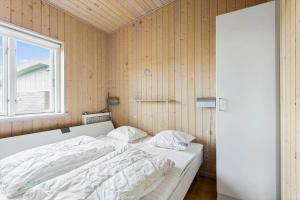 a bedroom with a white bed with a window at FY295-Faaborg-Mosegarden-39 in Faaborg