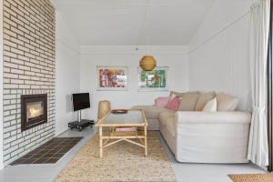 a living room with a couch and a fireplace at FY184-Asperup-Eskelundsvej-21 in Asperup