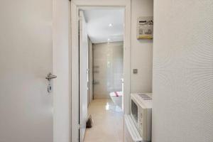 a white bathroom with a toilet and a hallway at FY155-Middelfart-Daemningen-99 in Middelfart +26 photos