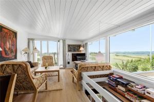a living room filled with furniture and a large window at FY270-Faaborg-Lille-Stege-7 in Faaborg