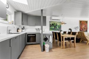 a kitchen with a table and a dining room at FY270-Faaborg-Lille-Stege-7 in Faaborg