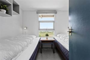 a small room with two beds and a window at FY270-Faaborg-Lille-Stege-7 in Faaborg