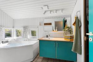 a bathroom with a large tub and a large sink at FY386-Hesselager-Stentoften-22 in Hesselager +31 photos