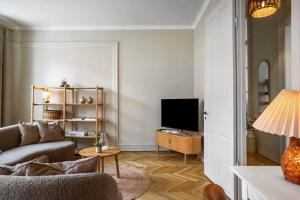 a living room with a couch and a television at FY399-Bogense-Ostergade-5-a in Bogense