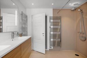 a white bathroom with a shower and a sink at FY399-Bogense-Ostergade-5-a in Bogense +37 photos