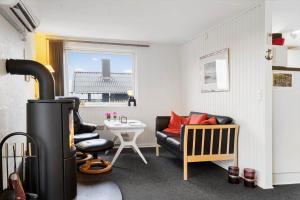 a living room with a couch and a stove at FY403-Asperup-Eskelundsvaenget-1 in Båring
