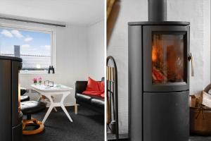 a living room with a fireplace and a room with a table at FY403-Asperup-Eskelundsvaenget-1 in Båring
