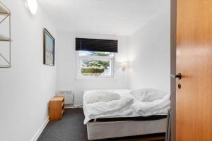 a small bedroom with a bed and a window at FY403-Asperup-Eskelundsvaenget-1 in Båring