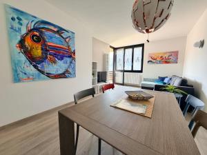 a dining room with a table and a painting on the wall at Prati Escape - Apartment with Pool and Lakeview in Lierna