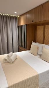 a bedroom with a large bed with white sheets at High Standard Two Bedroom Apartment Private Pool Frances Beach Garden 209 in Marechal Deodoro +24 photos